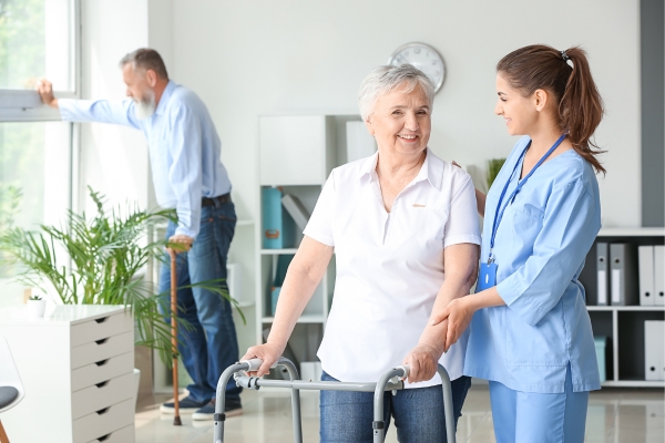 Nurse helping patient in clean nursing home