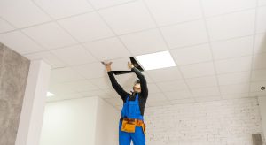 man cleaning ceiling