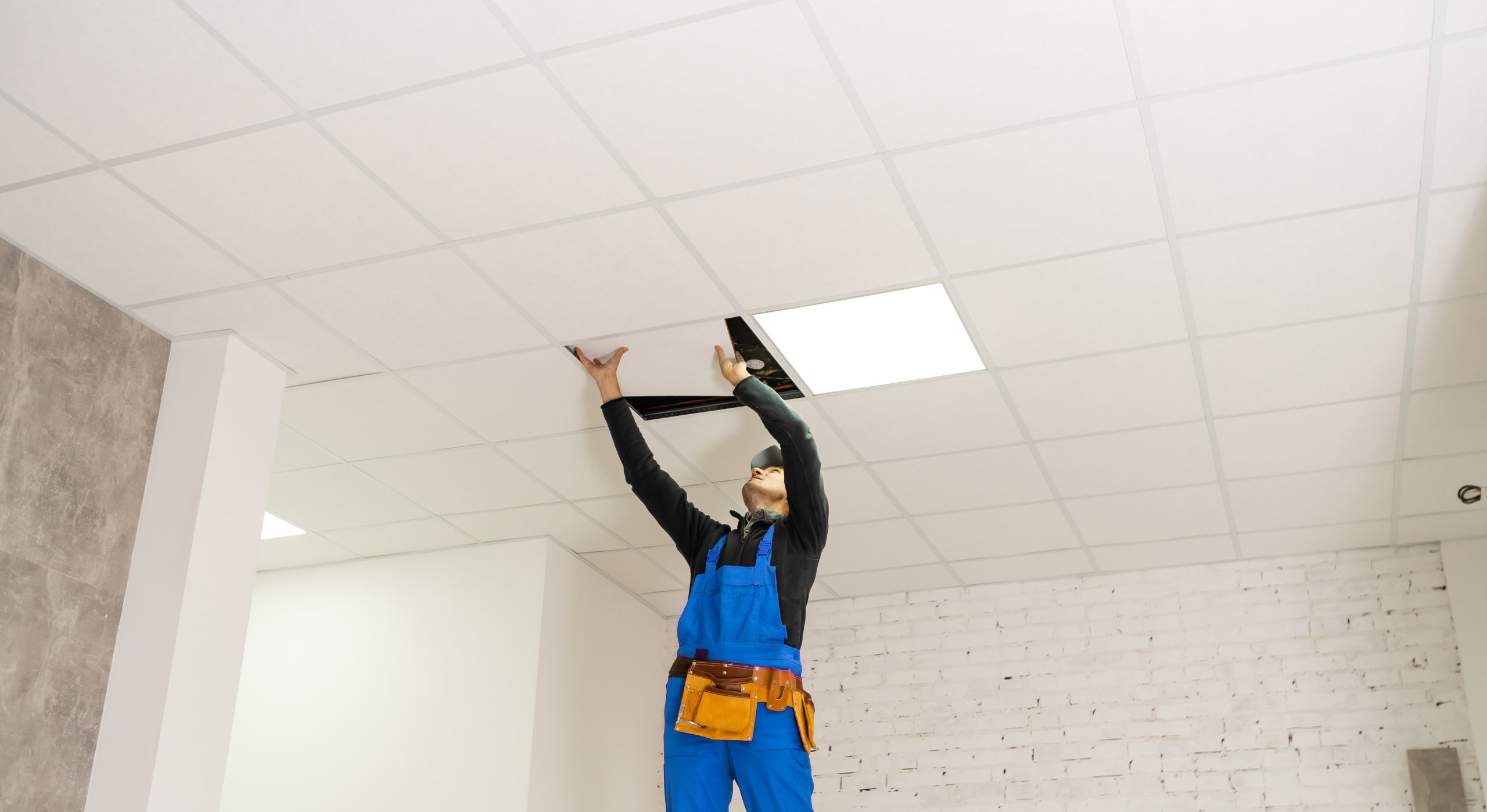 man cleaning ceiling